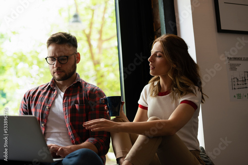 Young happy couple. Boyfriend and girlfriend drinking coffee together.