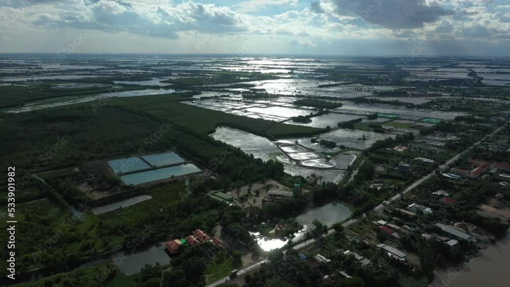Aerial fly in view over Mekong Delta agricultural land and waterways in Vietnam. Camera is shooting into the sun. Aerial fly in view over Mekong Delta agricultural land and waterways in Vietnam. Camera is shooting into the sun.