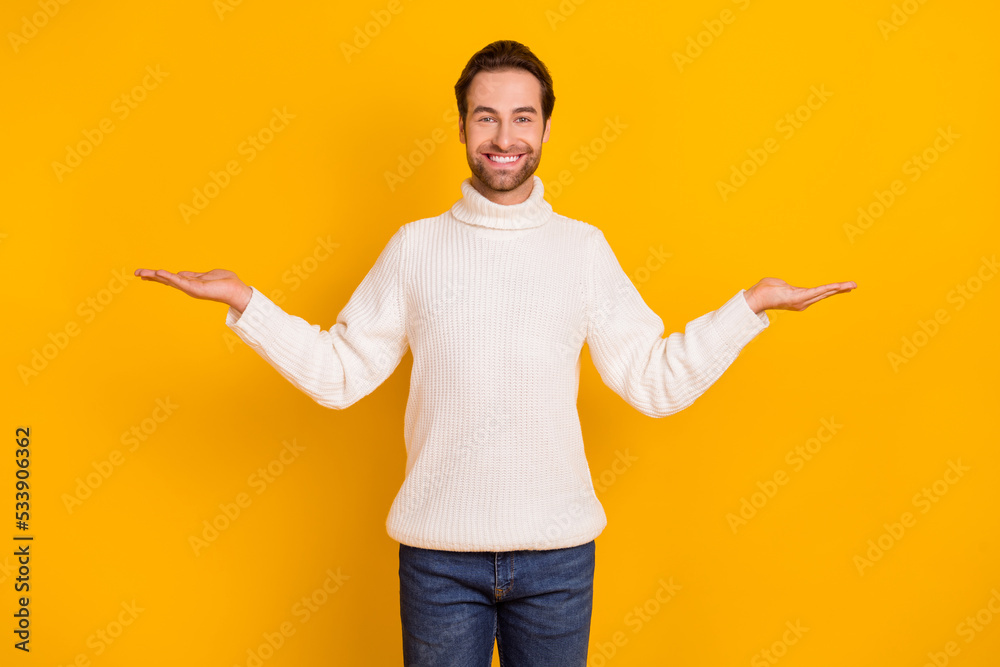Photo of funny dreamy guy dressed white sweater comparing arms copyspace isolated yellow color background Photo of funny dreamy guy dressed white sweater comparing arms copyspace isolated yellow color background