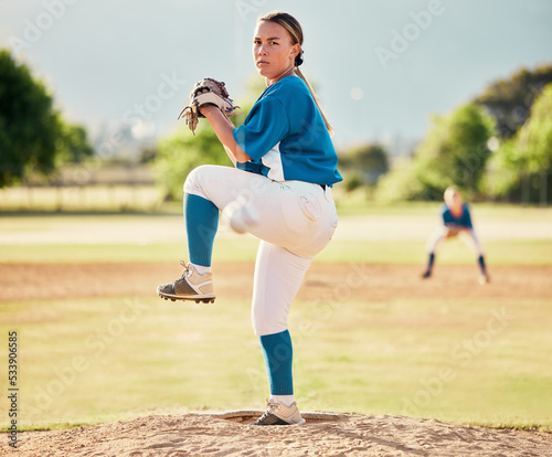 Baseball pitcher, ball sports and a athlete woman ready to throw and pitch during a competitive game or match on a court. Fitness, workout and exercise with a female player training outside on field