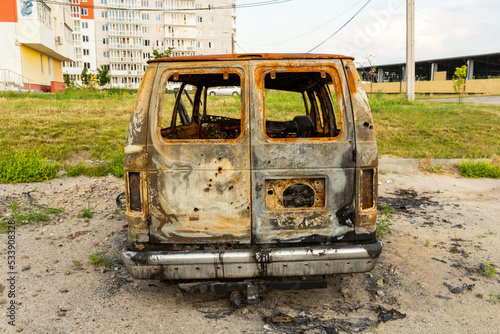 Damaged and destroyed civilian car with shrapnel holes from Russian missile in a war zone in Kharkiv, Ukraine