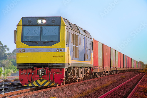 Container-freight train by diesel locomotive on the railway.