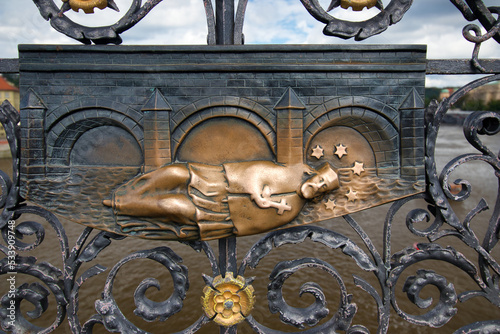Photography A detail view of iron forged grid with Saint John of Nepomuk relief on Charles Bridge in Prague, Czech Republic
