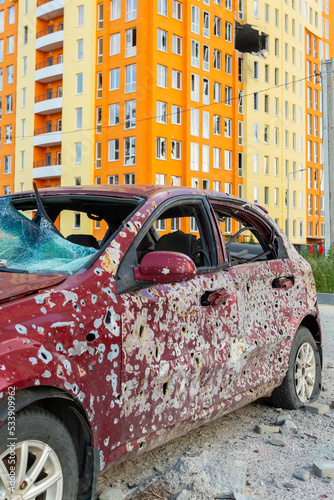Damaged and destroyed civilian car with shrapnel holes from Russian missile in a war zone in Kharkiv, Ukraine