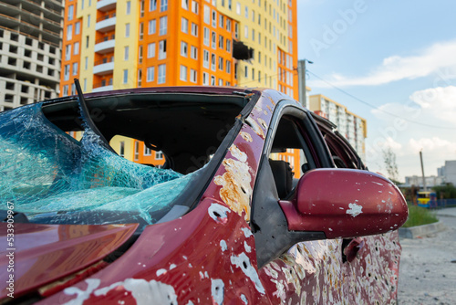 Damaged and destroyed civilian car with shrapnel holes from Russian missile in a war zone in Kharkiv, Ukraine