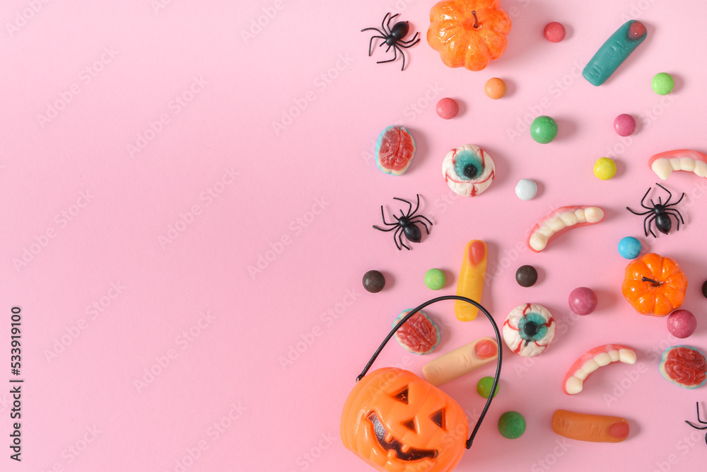 Banner with various sweets on a pink background. Happy Halloween. Space for copying. Flat position, top view
