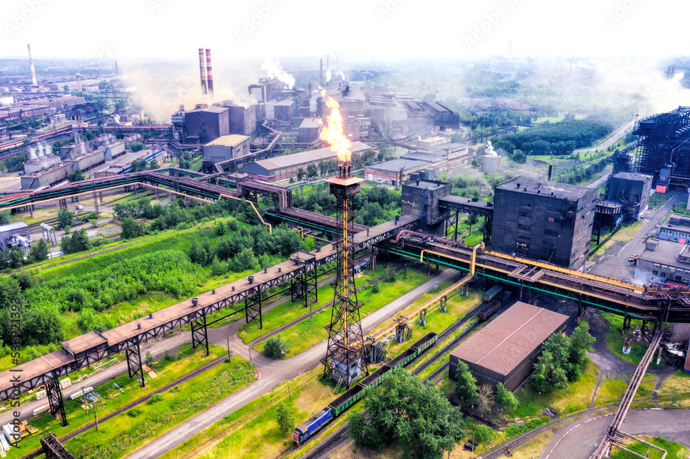 Fototapeta premium Factory chimney with burning flame