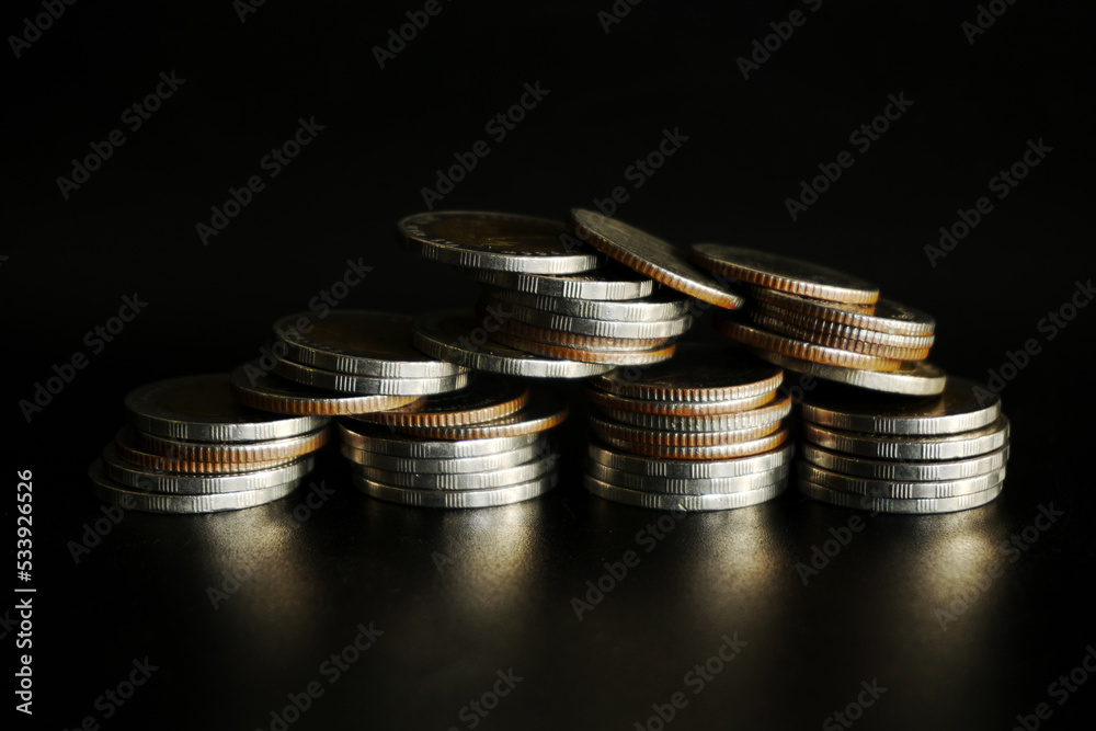 Stack of coins on black background, Saving money concept Stack of coins on black background, Saving money concept