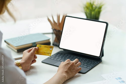 Close-up of woman enjoying online shopping with credit card payment. Pay by credit card on laptop at the office.