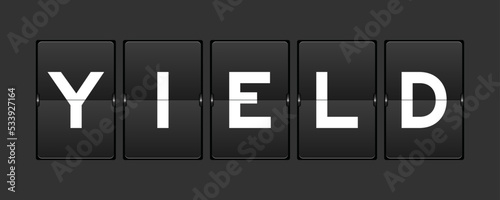 Black color analog flip board with word yield on gray background