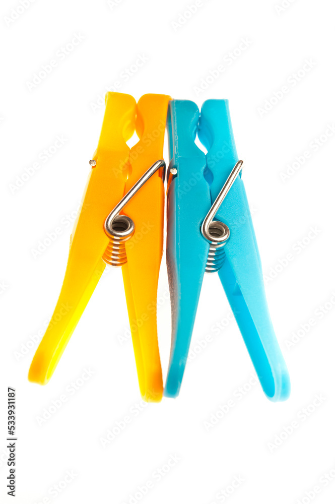 two clothes pegs blue and yellow, isolated two clothes pegs blue and yellow, isolated