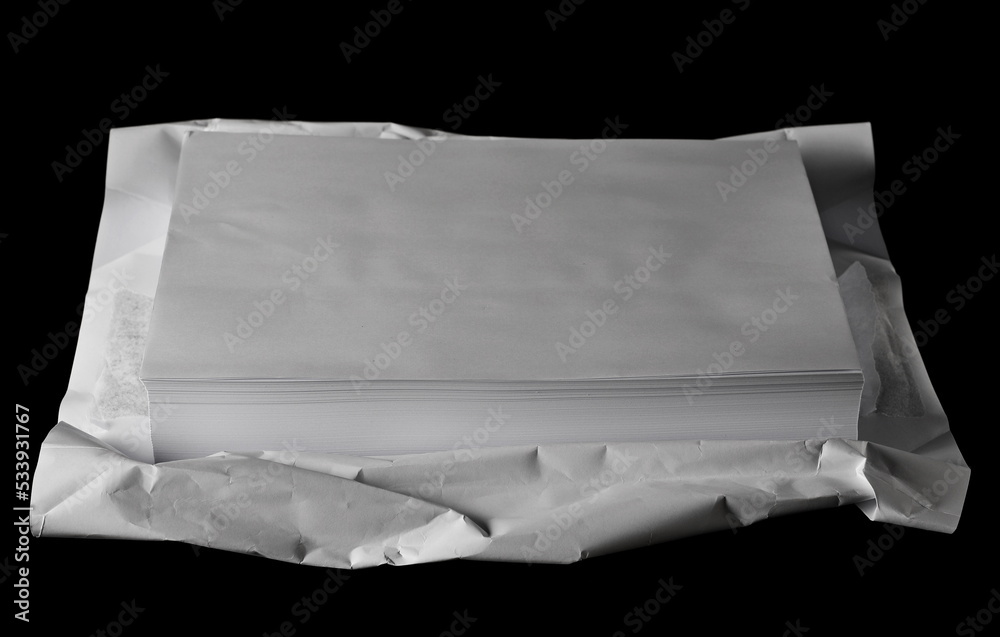 Stack white paper for writing and printing isolated on black background and texture