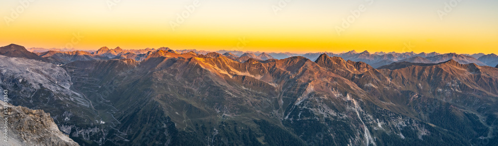 Alpine mountain peaks illuminated by rising sun