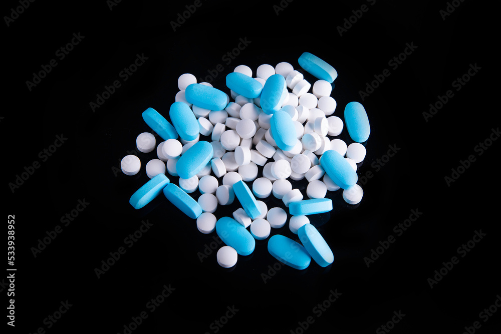 different medicine drugs, pills, tablets. pharmaceutical medicine pills on black background