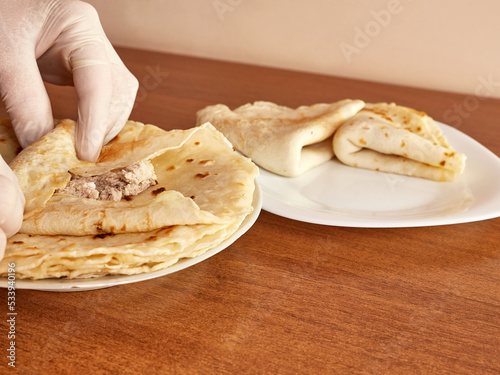 Cooking pancakes with meat filling. The concept of home cooking.