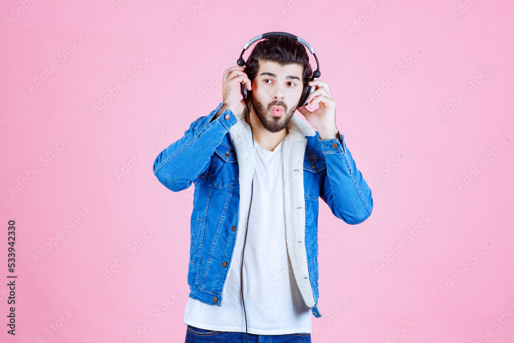 Man with headphones looks confused Man with headphones looks confused