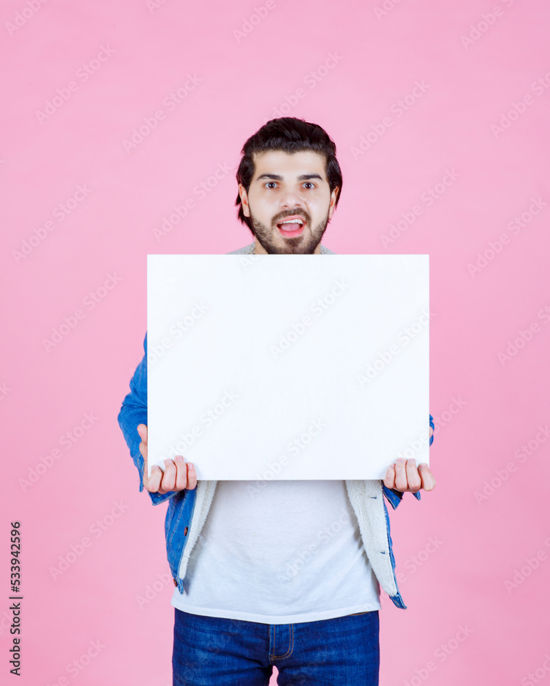Man holding a square shape thinkboard and enjoying it Man holding a square shape thinkboard and enjoying it