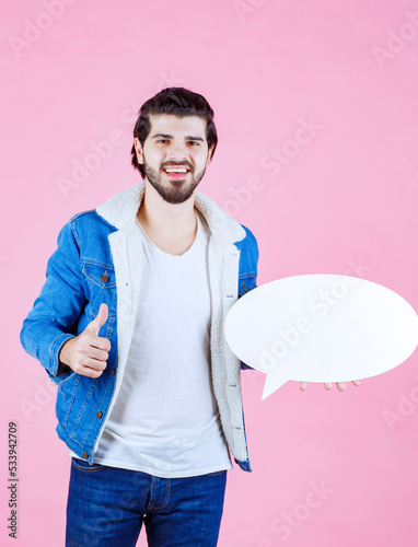 Man holding a blank ideapad and showing thumb up photo