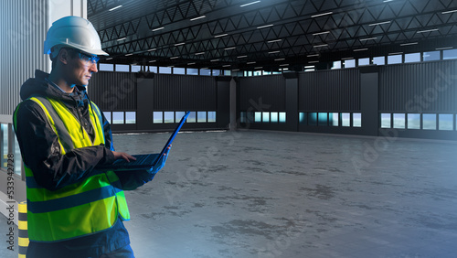 Builder in empty hangar. Ma...