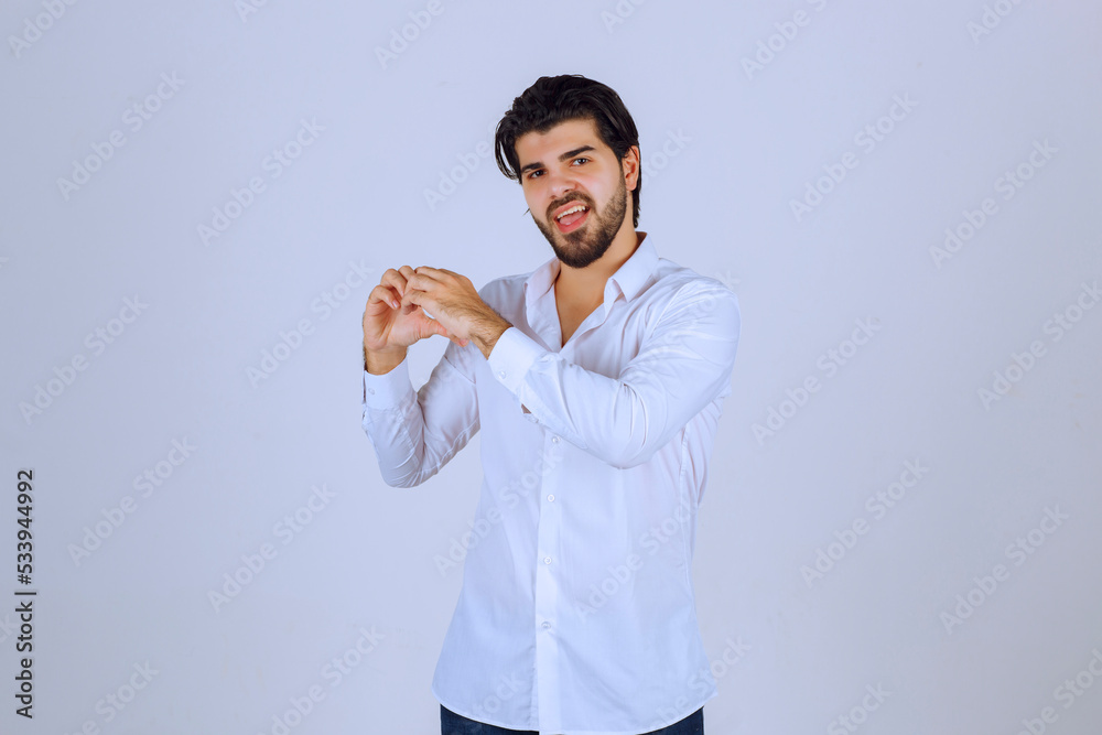 Man in white shirt sending love and heart Man in white shirt sending love and heart