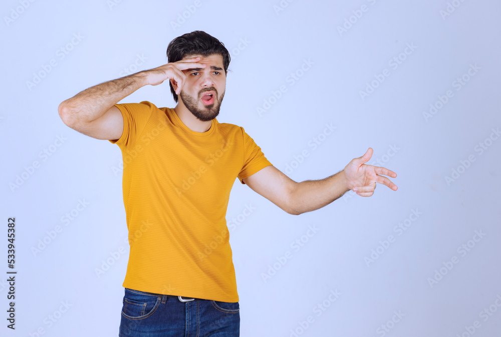 Man looking through his fingers Man looking through his fingers