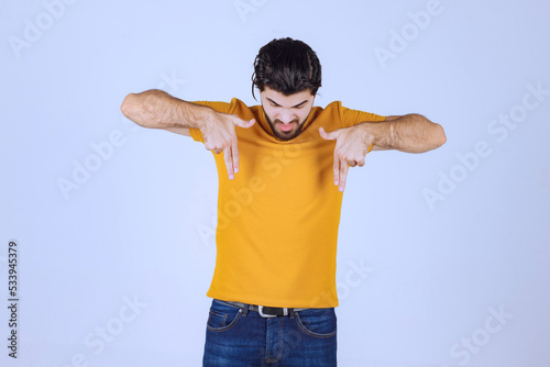 Man showing dislike hand sign photo