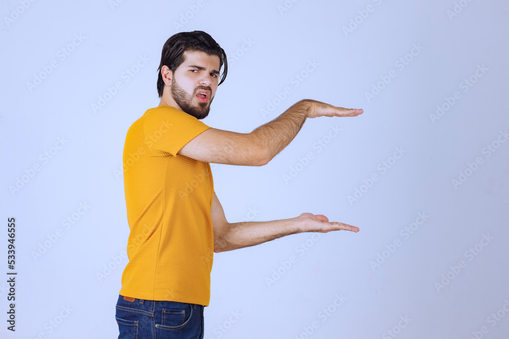 Man with beard showing estimated measures of an object Man with beard showing estimated measures of an object