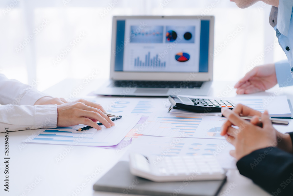 Two young business people working together at office, talking, discussing and analyzing business strategy. Two young business people working together at office, talking, discussing and analyzing business strategy.
