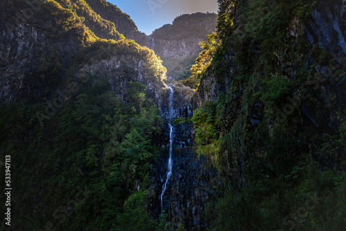 Waterfall surrounded by luxurious vegetation at the end of the Levada do Risco route in Rabaçal, Madeira island