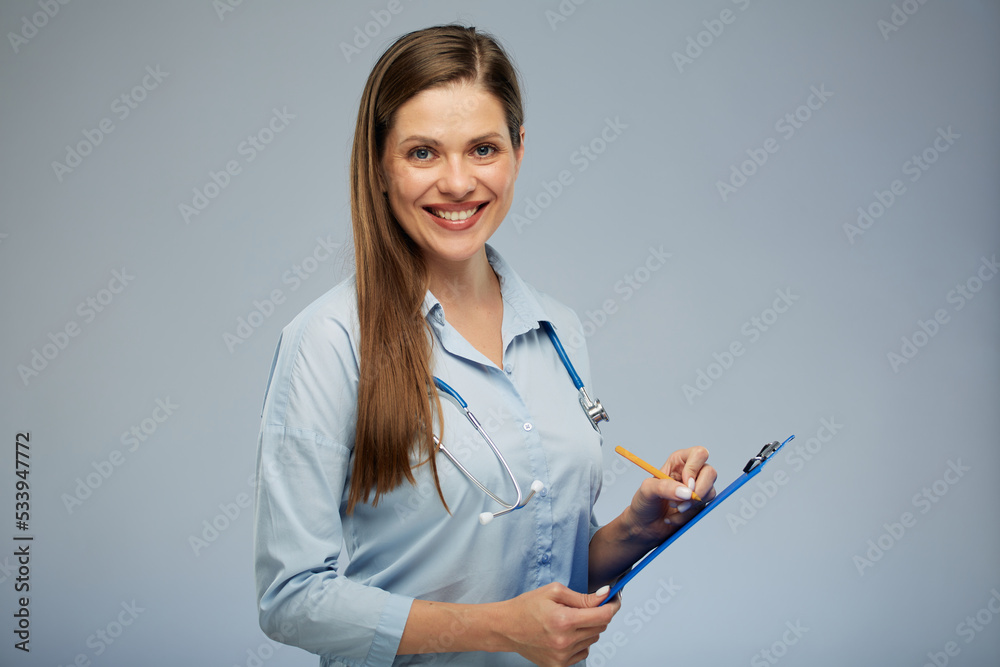 Smiling female doctor writing on a tablet. Isolated portrait of doctor woman. Smiling female doctor writing on a tablet. Isolated portrait of doctor woman.