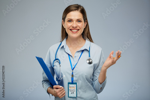 Smiling doctor woman or health Insurance agent holding blue clipboard. Isolated portrait of female medical worker
