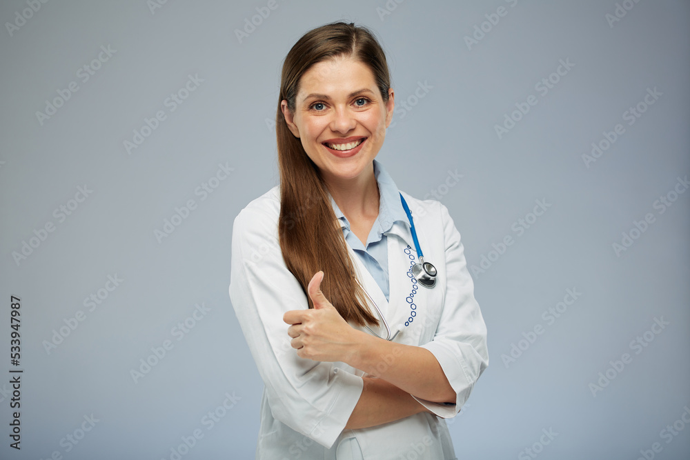 Doctor woman in white coat showing thumb up. Isolated portrait of female medical worker Doctor woman in white coat showing thumb up. Isolated portrait of female medical worker
