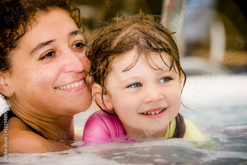 Beautiful young girl and her mom having fun in a hot tub © Image'in