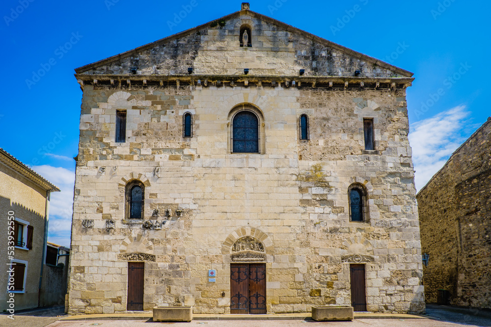 View on the 12th century facade of the Saint Pierre de Champagne romanesque church in Ardeche (France)