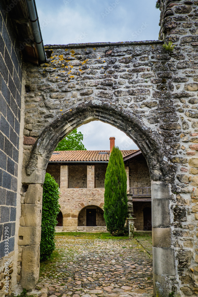 view on a barrel vault entrance to the Saint Agnes priory cloister in Saint Jean de Galaure in Drome (France)