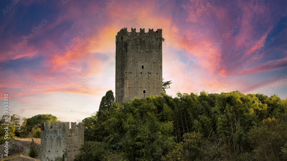The castle tower of the garden of Ninfa in Cisterna di Latina, Norma, near Rome Italy. Natural monument in Italy. The garden is in English style. Romantic medieval knight view