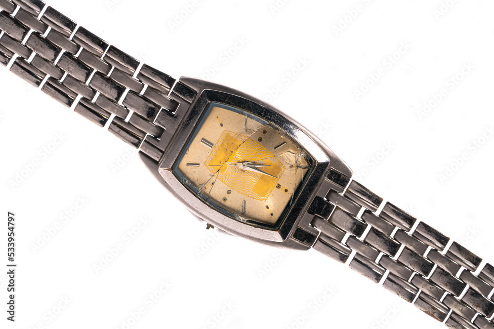 Old metal wrist watch with damage dial on white isolated studio background. Broken retro watch with silver bracelet. There are cracks and damages on glass of wrist watch dial. Old metal wrist watch with damage dial on white isolated studio background. Broken retro watch with silver bracelet. There are cracks and damages on glass of wrist watch dial.
