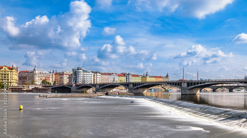 The Dancing House and Jiraskuv bridge over the river Vltava in Prague