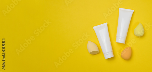 White plastic tubes for cream, gel and other cosmetics and sponges