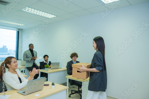 New colleague is coming into the office. Asian woman coming to the office in first time and greeting by her colleague.