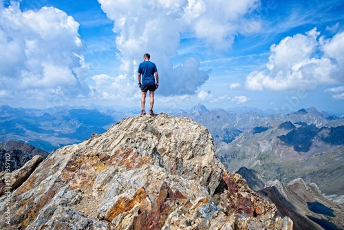 Man on summit of Garmo Negro looking away from the camera, in the Valle de Tena region of Aragon, Spain photo