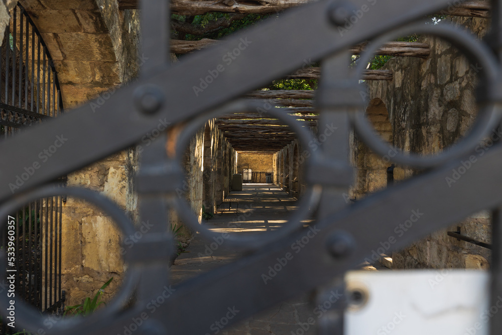 The Alamo side barracks looking through an iron gate The Alamo side barracks looking through an iron gate