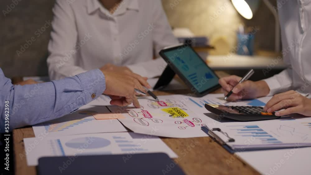 Business people pointing to graph and chart to analyze market, sale, balance sheet, account, net profit data to see the growth of the organization and to develop product. Business people pointing to graph and chart to analyze market, sale, balance sheet, account, net profit data to see the growth of the organization and to develop product.