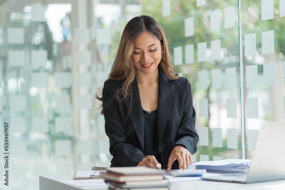 Confident asian businesswoman working in office workstation. Confident asian businesswoman working in office workstation.
