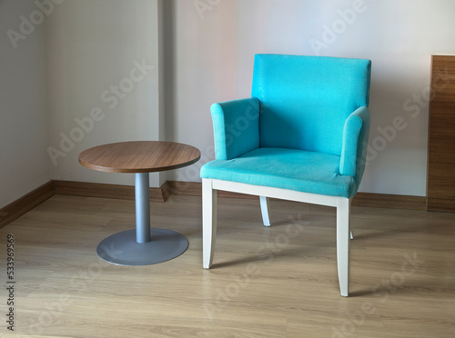 Round small table and turquoise armchair
