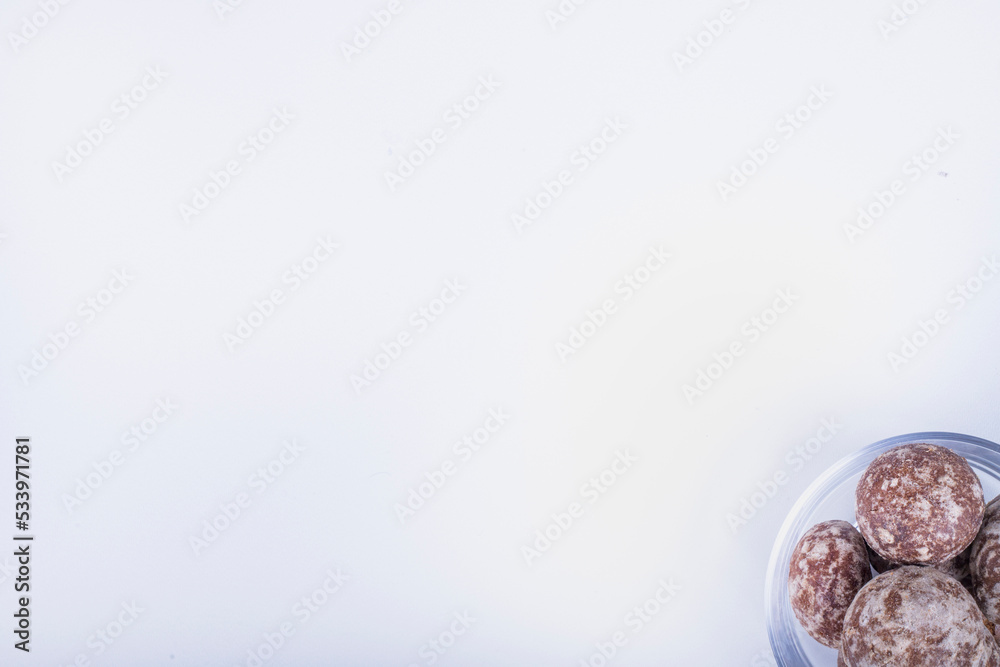 Cocoa gingerbreads in a glass cup on white background Cocoa gingerbreads in a glass cup on white background