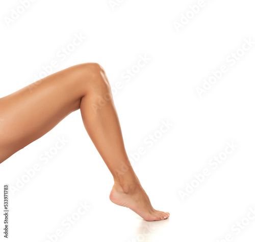 Beautiful well-groomed women's leg close-up on a white isolated background,