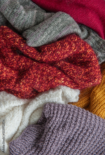 Autumn and winter background of knitted colourful sweaters