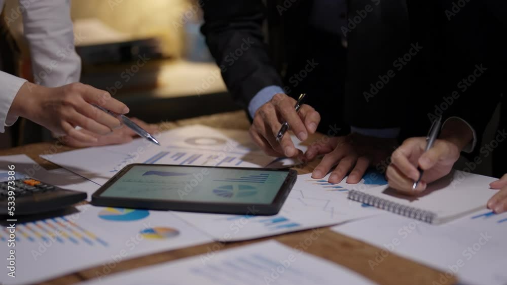 Business people pointing to graph and chart to analyze market, sale, balance sheet, account, net profit data to see the growth of the organization and to develop product. Business people pointing to graph and chart to analyze market, sale, balance sheet, account, net profit data to see the growth of the organization and to develop product.