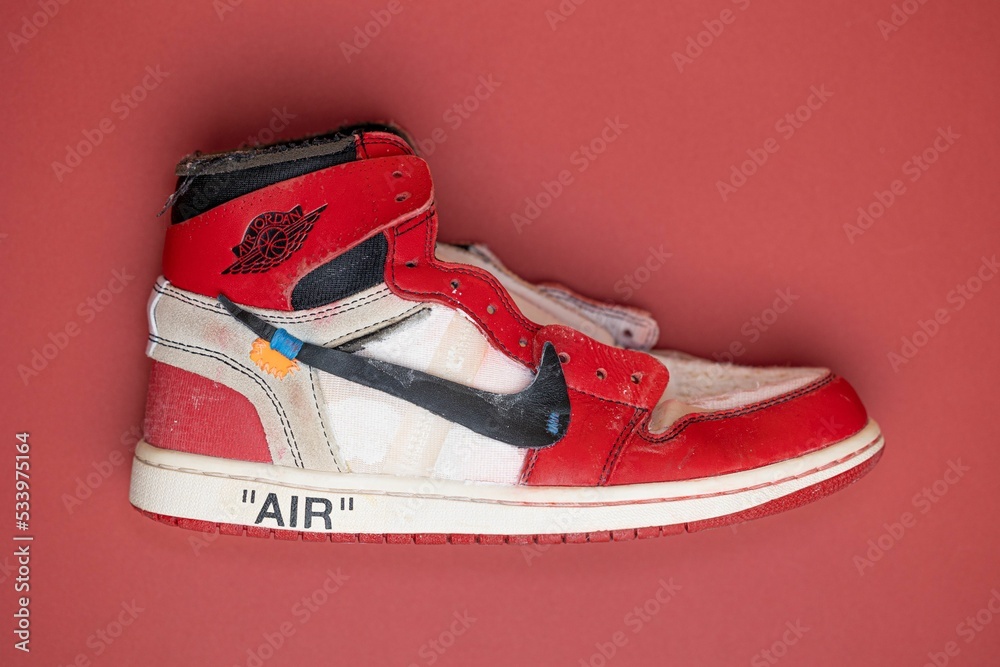 Red Air Jordan 1 Off White from Nike. The Ten Air Jordan 1. Crooked Nike  Swoosh. Beaten up shoes. Stock Photo | Adobe Stock
